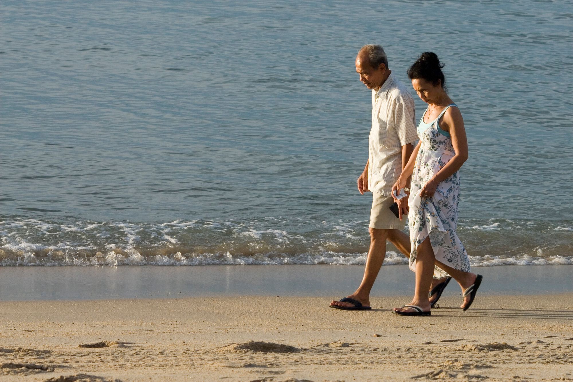 Couple walking along the beach